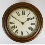 A late 19th Century school house oak wall clock, the 10" dial with Roman numerals, pendulum.