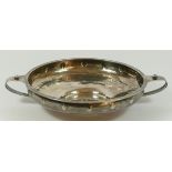 An Arts & Crafts two handled shallow bowl by A.E. Jones, Birmingham 1918, with a plain rim, the bent