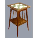 An Arts and Crafts oak tapering occasional table, with chequerboard tile insert, 40 x 70cm.