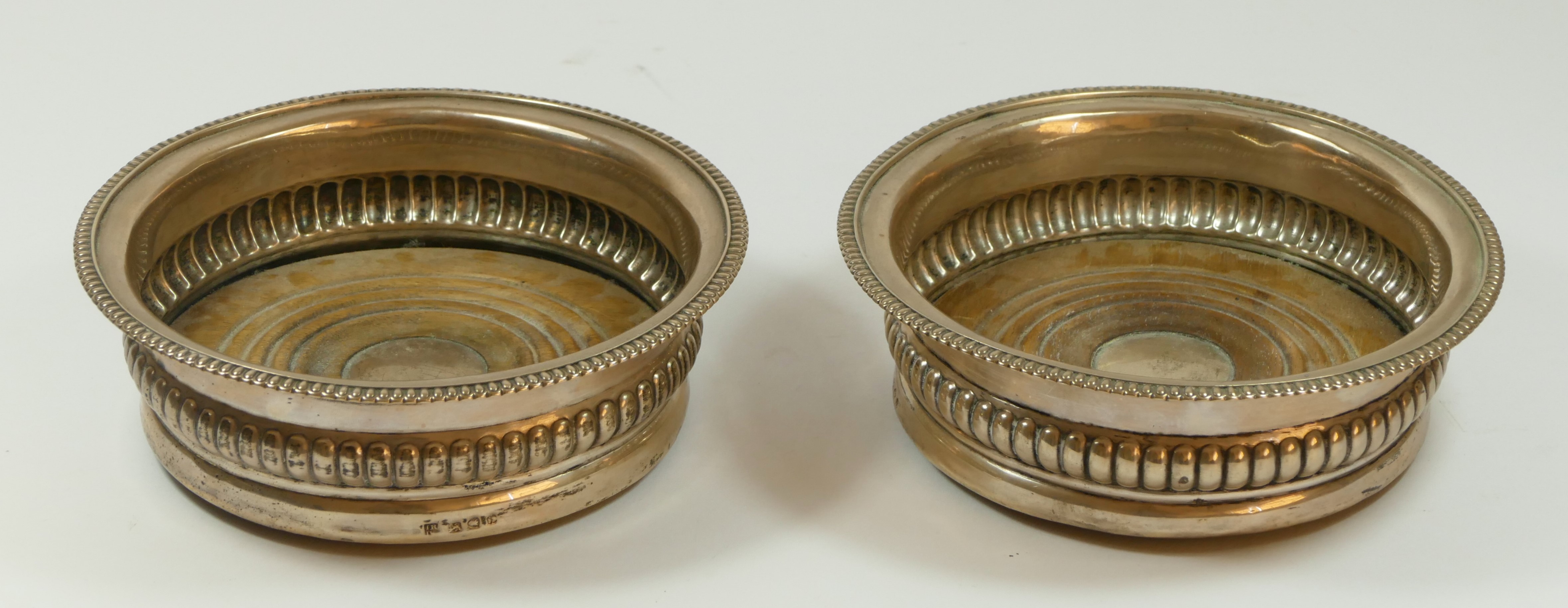 A George III Provincial silver pair of bottle coasters, by Robertson & Watson, Newcastle c.1808,