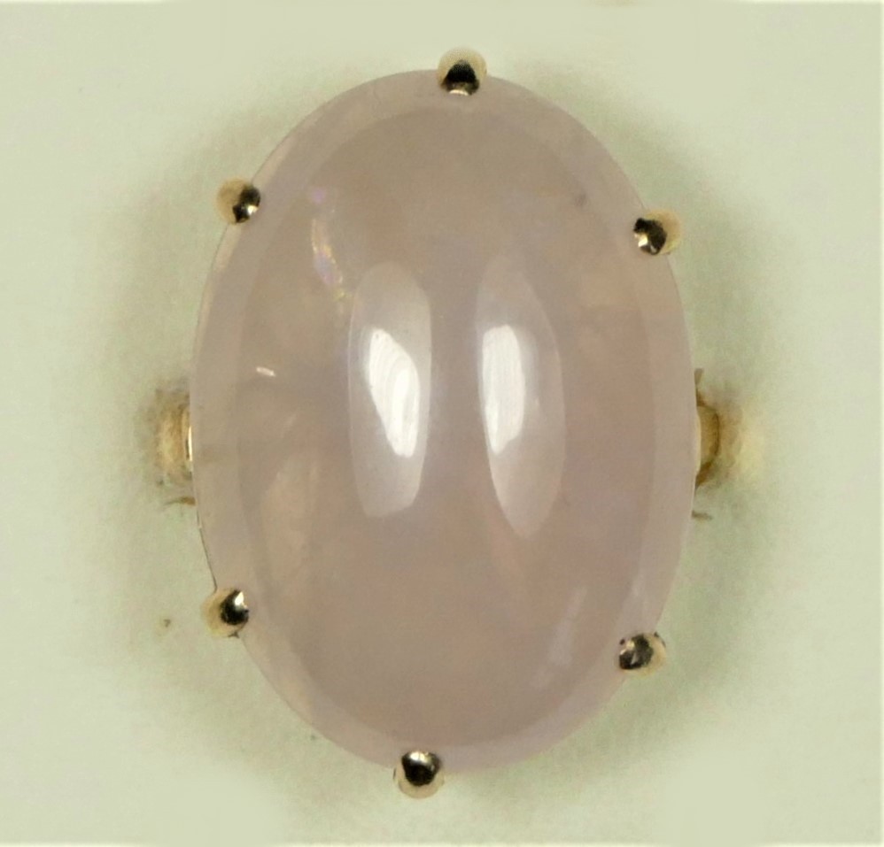 A 9ct rose gold vintage rose quartz dress ring, Birmingham 1975, claw set with a cabochon stone,