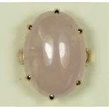 A 9ct rose gold vintage rose quartz dress ring, Birmingham 1975, claw set with a cabochon stone,