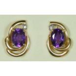 A 9ct gold pair of amethyst and diamond scroll ear studs, 3.6gm