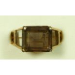 A 9ct gold and smokey quartz dress ring, London 1969, claw set with a step cut stone, 12 x 10mm,