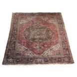 A Persian Hamaden rug, with deep red field, palmette and floral border, 240 x 322cm.