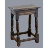 A 17th century oak joint stool, with plank top and thumb nail edge, line incised frieze, on turned