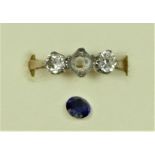 An 18ct gold sapphire and diamond three stone, the mixed cut stone flanked by old diamonds of