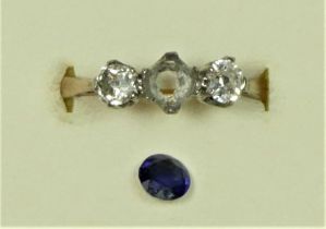 An 18ct gold sapphire and diamond three stone, the mixed cut stone flanked by old diamonds of