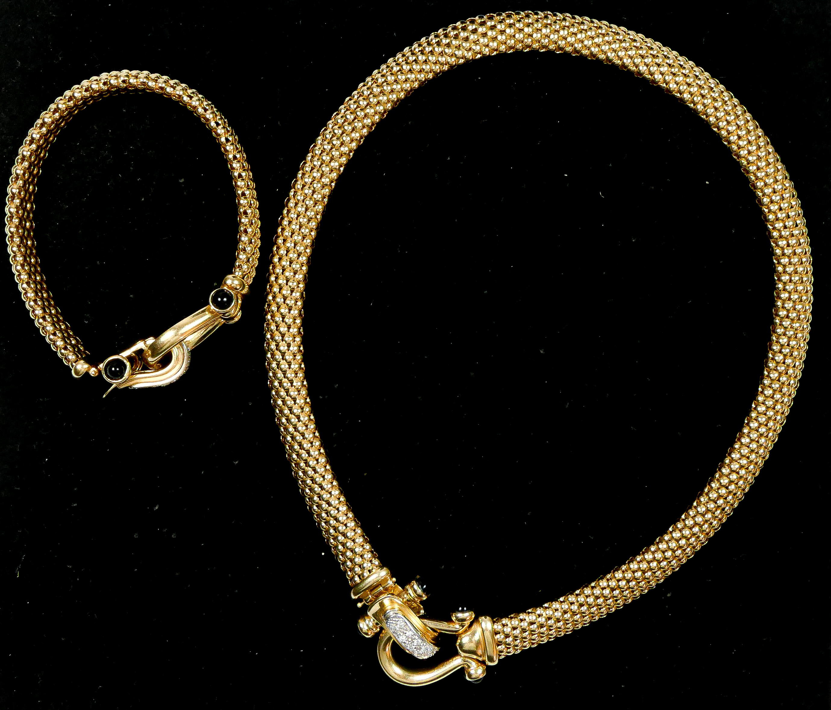 A 14K gold, diamond and onyx basket weave necklace, the stirrup clasp set with brilliant cut