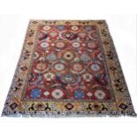 A Turkish Konya rug with multi-coloured guls on a brick red field, palmette and gul border, 290 x