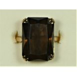 A 9ct gold and smokey quartz vintage dress ring, Birmingham 1966, claw set with a step cut stone, 18