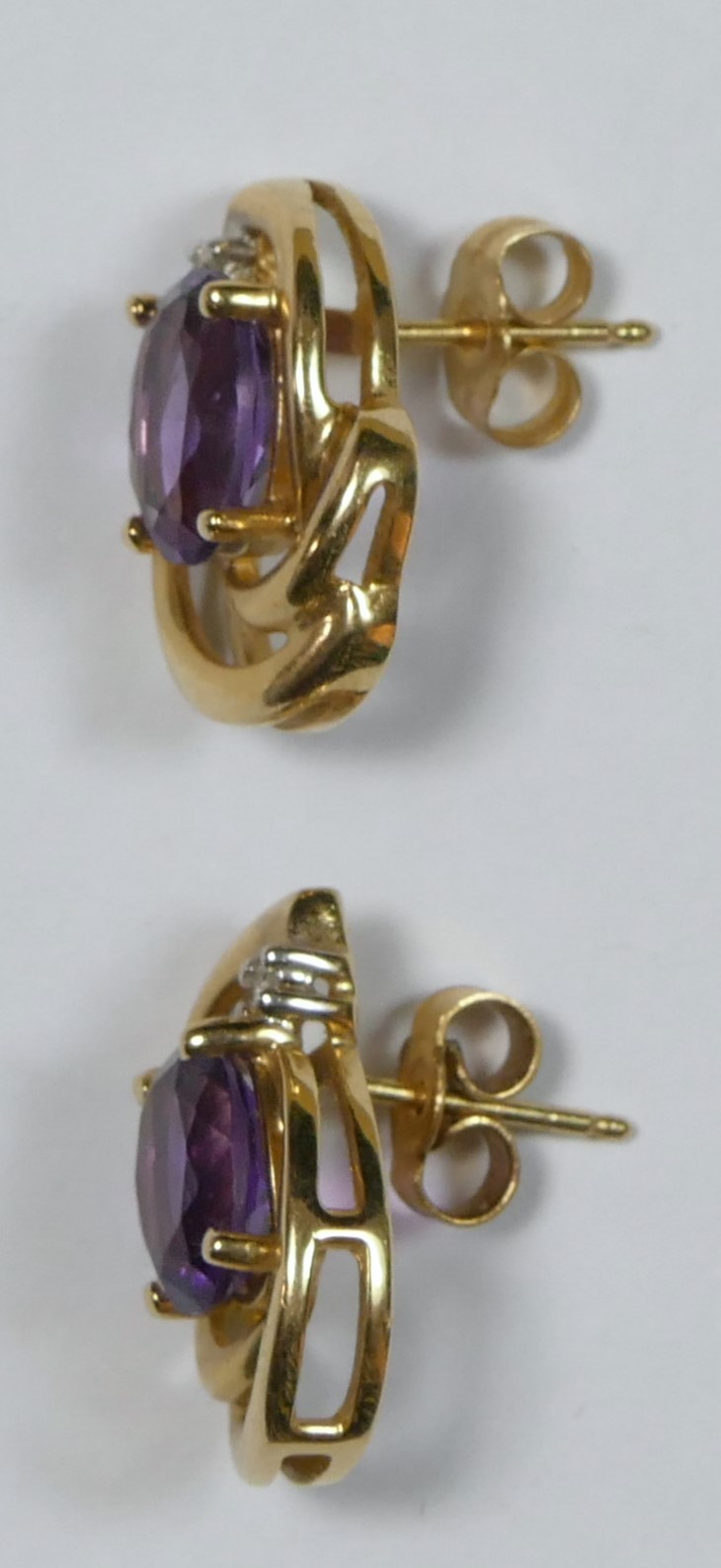 A 9ct gold pair of amethyst and diamond scroll ear studs, 3.6gm - Image 2 of 2