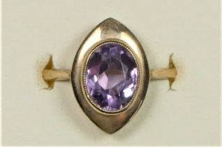 A 9ct rose gold and amethyst dress ring, milligrain collet set with a mixed cut stone, Q, 3.5gm