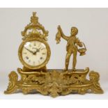 An Italian brass 8 day mantel clock, the eight day clock with boy holding a fish, raised on a scroll