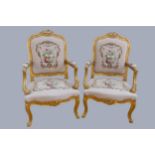 A Louis XV style giltwood and petite point embroidered pair of armchairs, to match the previous lot,