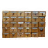 A Victorian set of 30 Apothecary pitch pine drawers, most with the original glass medicine