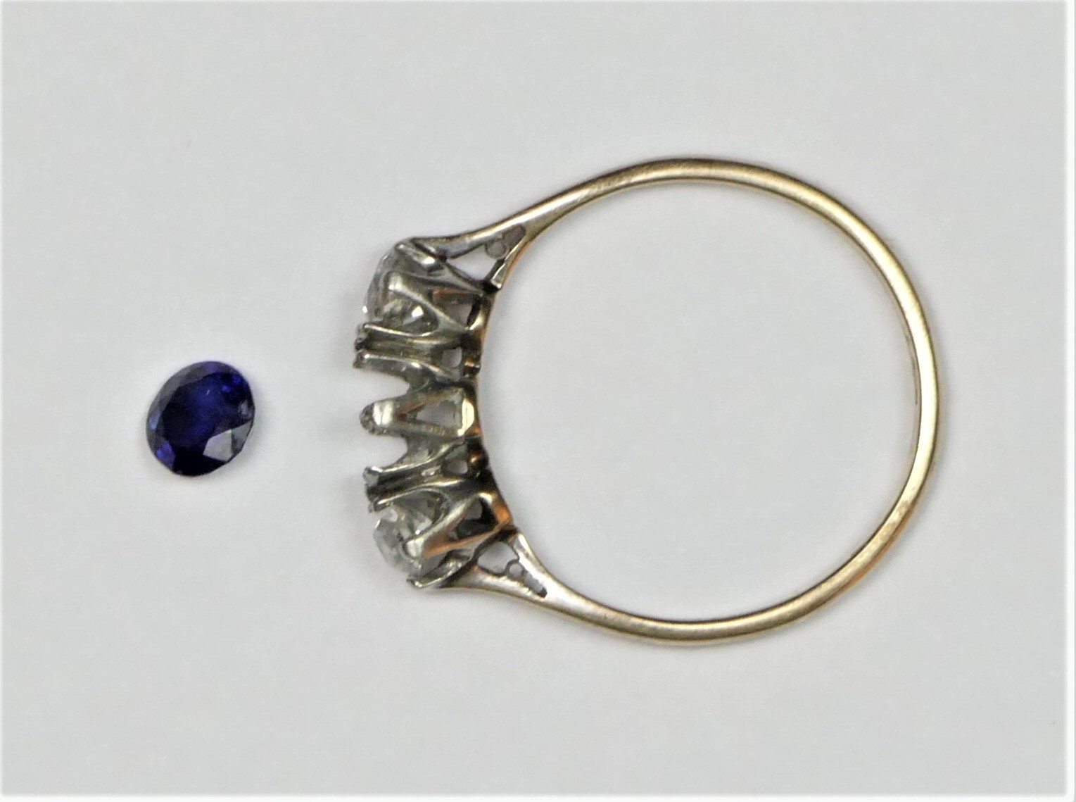 An 18ct gold sapphire and diamond three stone, the mixed cut stone flanked by old diamonds of - Image 3 of 3