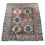 A Caucasian Kazak rug, with brick red field, 180 x 195cm