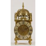 A late 19th Century brass lantern clock, the silvered dial with Roman numerals, the French