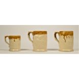 Two Kilnhurst/Twigg pottery pint mugs and a half pint mug, each with moulded decoration and brown
