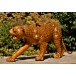 A paper mache sculpture, in the form of a leopard, plastic teeth and whiskers, 100cm x 70cm x 30cm