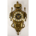 An early 20th century French brass wall clock, the dial with porcelain Roman numerals, cast lyre and