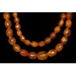 A Victorian facetted honey colour amber bead two row graduated necklace, 19 x 14 to 8 x 12mm, 78gm