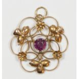 An Edwardian 9ct rose gold and garnet openwork scroll pendant, 9c tab, 25 x 25mm, 1.7gm