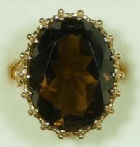 A 9ct gold citrine dress ring, London 1992, claw set with an oval mixed cut stone, 20 x 15mm, ornate
