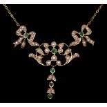 A gold, emerald and half pearl scroll and bow necklace, tests as 18ct, set with mixed cut stones,