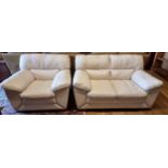 A cream leather two seater sofa, white stitching on wooden feet, 165cm x 110cm x 100cm, together