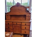 A Victorian waxed pine chiffonier, shaped top with two banks of three drawers over three frieze