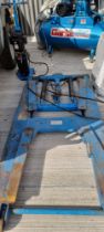 A hydraulic four arm car ramp, with pump, in recent use, for sale due to closure of business