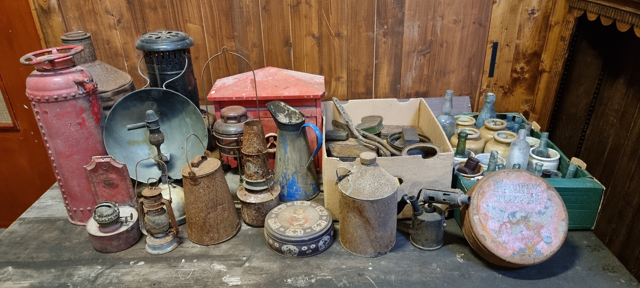 A John Kerr & Co fire extinguisher, a metal letter box, various old bottles and stoneware jars and