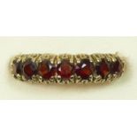 A 9ct gold seven stone garnet ring, L, 1.7gm