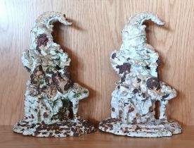 A pair of cast iron Punch door stops, painted, 33cm tall