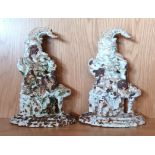 A pair of cast iron Punch door stops, painted, 33cm tall