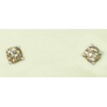 A pair of 18ct gold and diamond earstuds, four claw set with brilliant cut stones of approximately