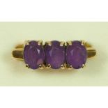 A 9ct gold three stone amethyst ring, Birmingham 1979, U, 4.7gm