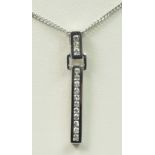 A 9ct white gold and brilliant cut diamond line pendant, chain, 2.4gm