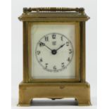 A late 19th century carriage clock by Waterbury Clock Co U.S.A. having brass case and enamelled dial