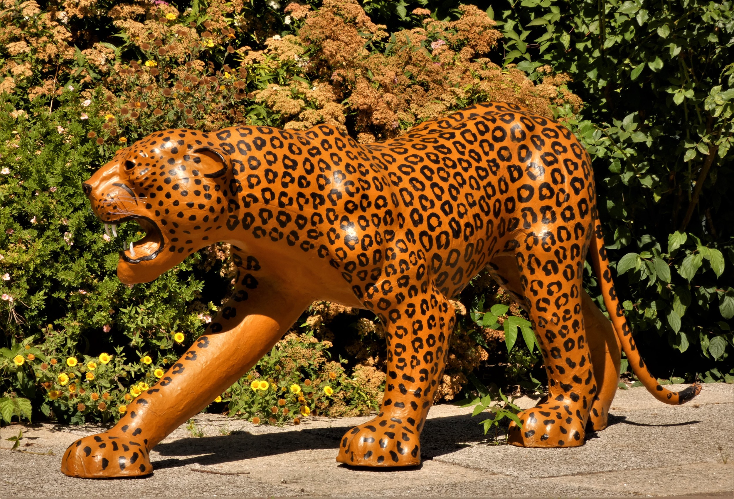 A paper mache sculpture, in the form of a leopard, plastic teeth and whiskers, 100cm x 70cm x 30cm