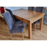 An oak extending dining table raised on block legs, 140 x 90 x 78cm extending to 220 x 90 x 78cm,