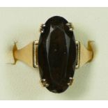 A 9ct gold and smokey quartz dress ring, claw set with an oval mixed cut stone, 19 x 9mm, O, 4.6gm