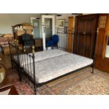 Two metal framed single beds, black with brass coloured decoration, from Enchanted House Beds,