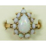 A 9ct gold pear shape opal cluster ring, 15 x 12mm overall, N 1/2, 4gm