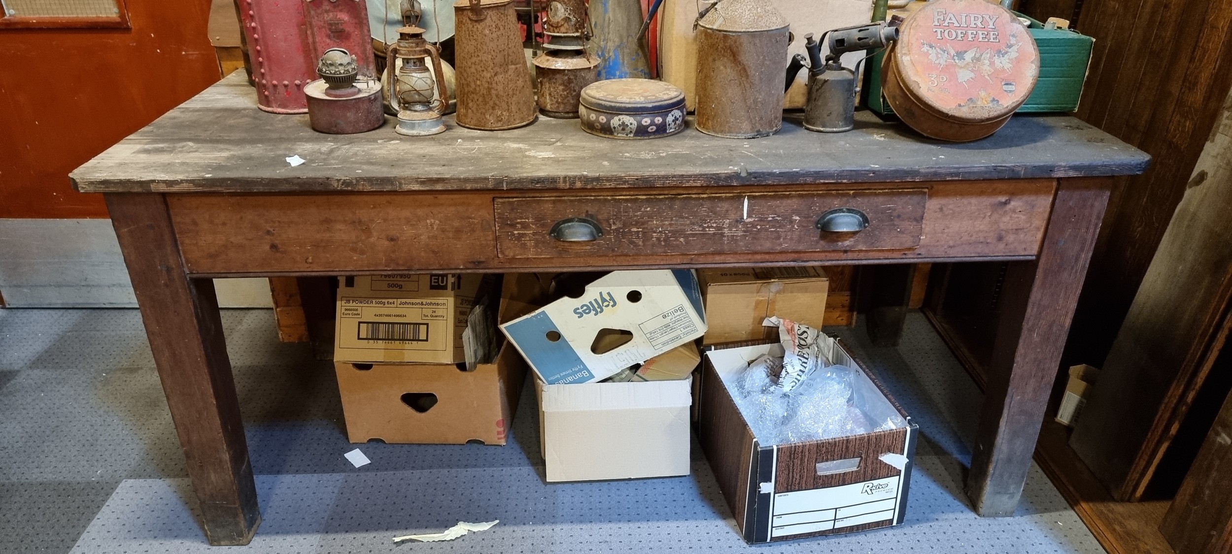 An Industrial pitch pine work table, with off centre frieze drawer and stenciled 145 and S61, oil