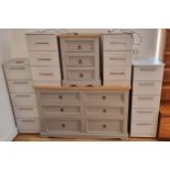 A painted pine chest of three short drawers, 132 x 50 x 184, together with a matching bedside drawer