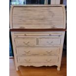 A Laura Ashley 'Bramley' distressed French style white painted roll top desk, opening to reveal a
