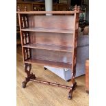 A Victorian Gothic Revival mahogany free standing bookcase with arch pierced sides. 193 x 46 x 145cm